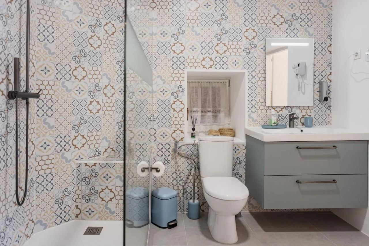 Bathroom with patterned tiles and a walk-in shower