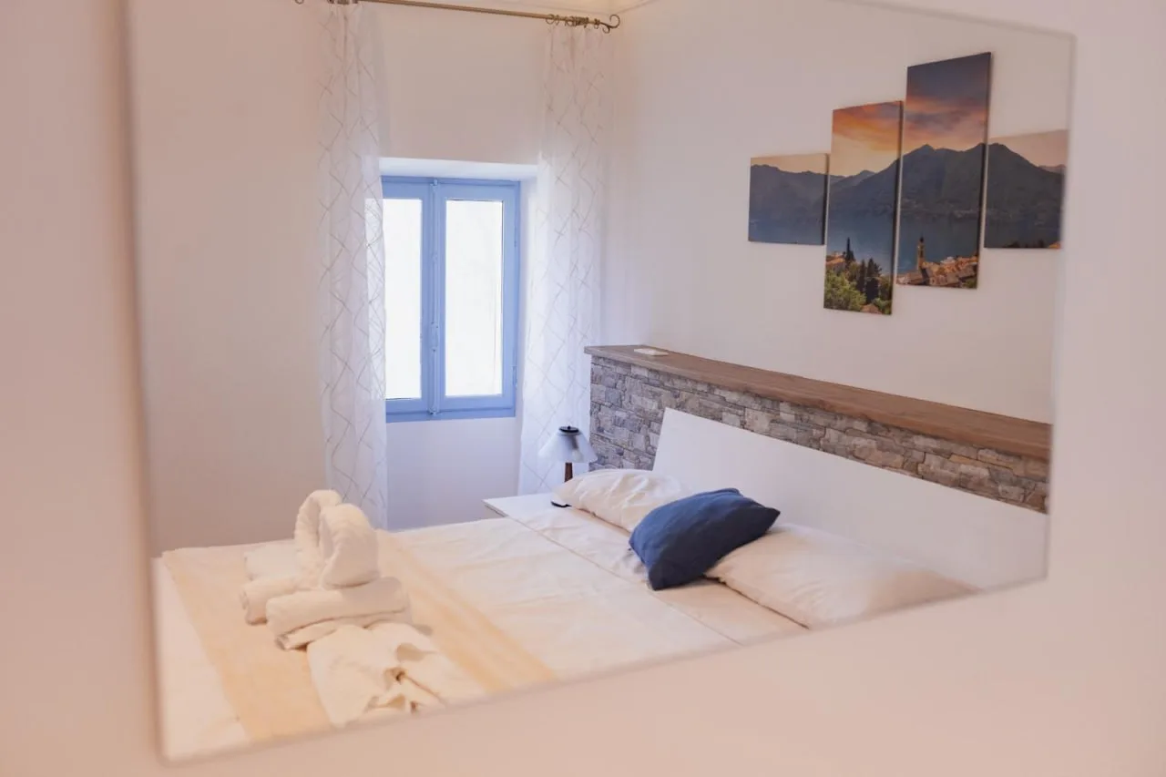 First bedroom beside the blue-framed window