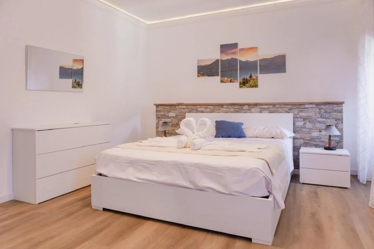 First bedroom with a stone-effect headboard