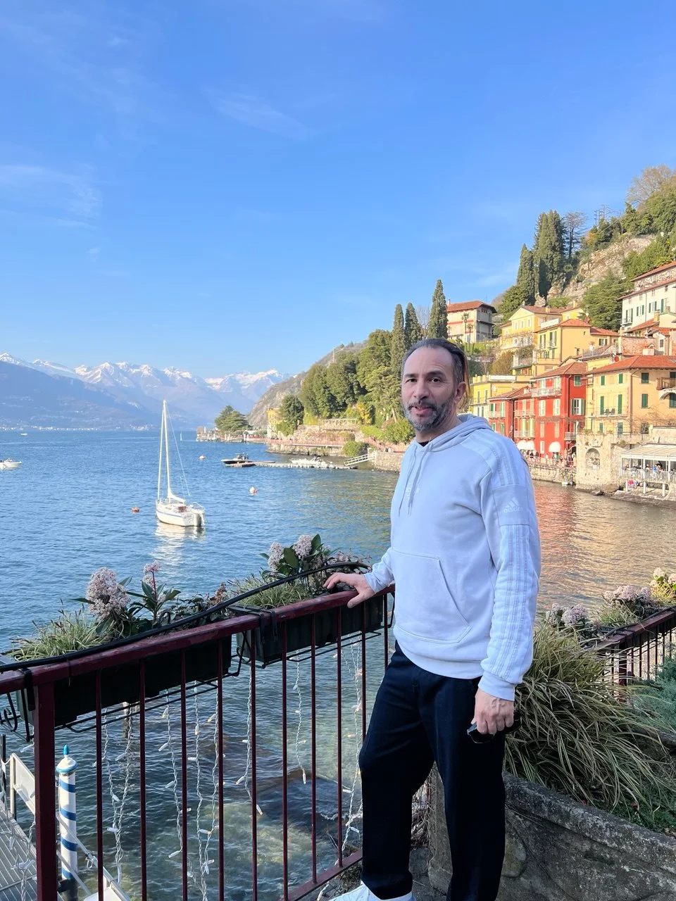 Vittorio overlooking Lake Como from a colourful lakeside village