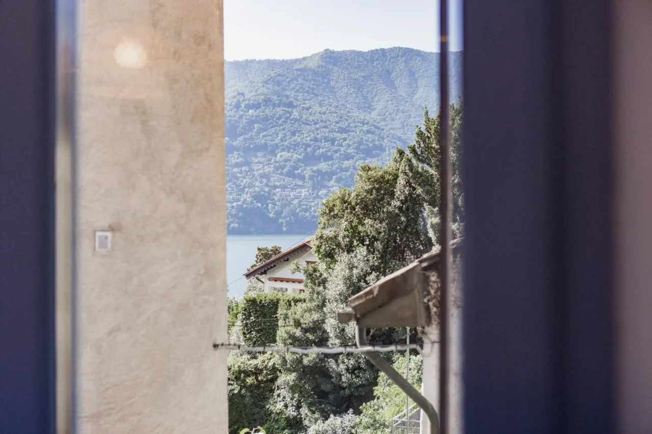 Lake glimpse from a window of the apartment in Laglio
